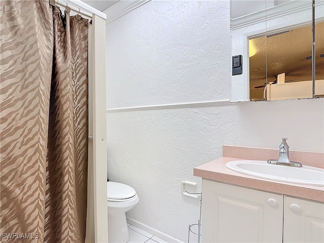 full bath featuring a textured wall, tile patterned flooring, toilet, vanity, and baseboards