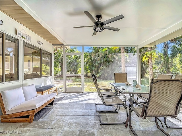 sunroom / solarium with a ceiling fan