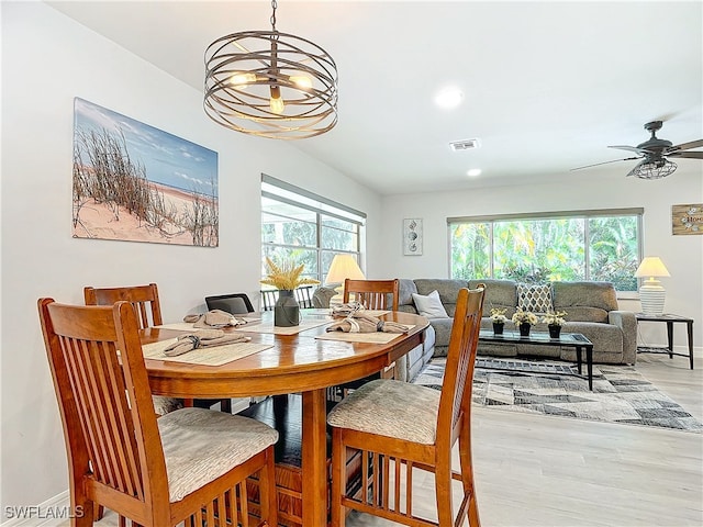 dining space with a healthy amount of sunlight, light wood-style floors, baseboards, and visible vents