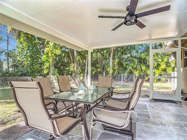 sunroom / solarium featuring ceiling fan