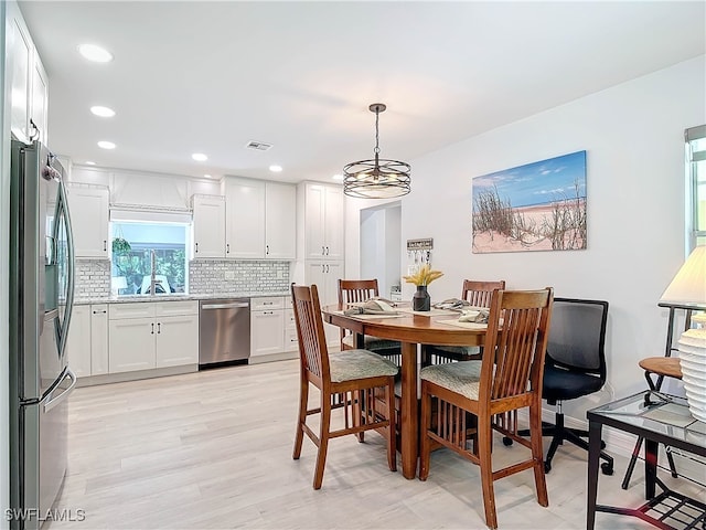 dining room featuring light wood-type flooring, visible vents, and recessed lighting