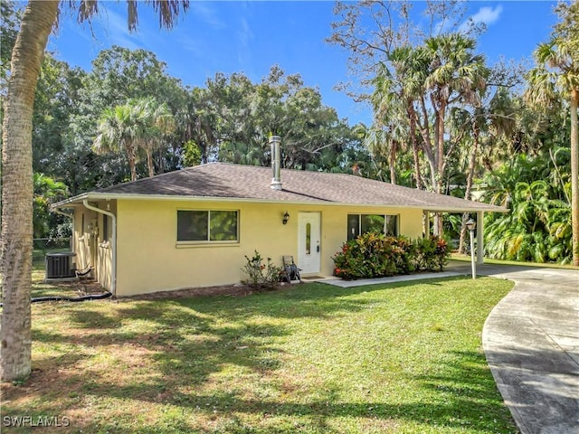 view of front of home featuring roof with shingles, a front lawn, and stucco siding