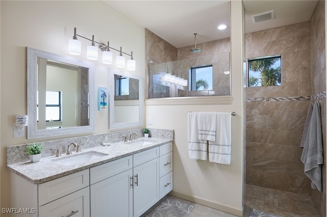 bathroom featuring vanity and tiled shower