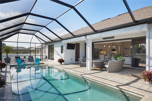 view of pool featuring a lanai, a patio area, and outdoor lounge area