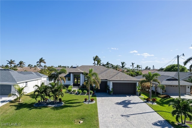 view of front of property with a front lawn and a garage