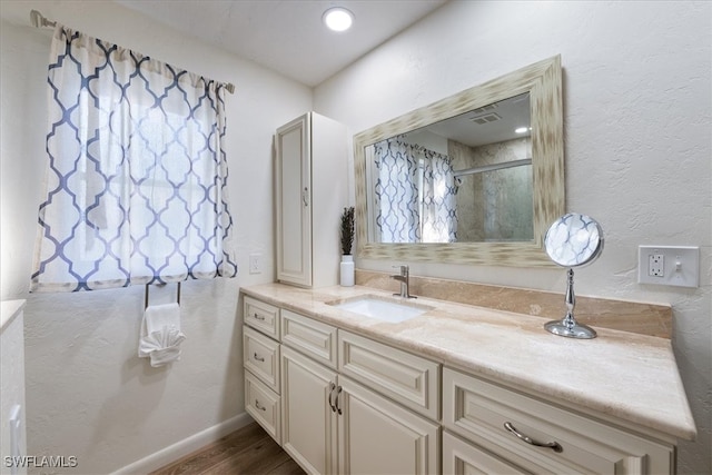 bathroom with vanity and wood-type flooring