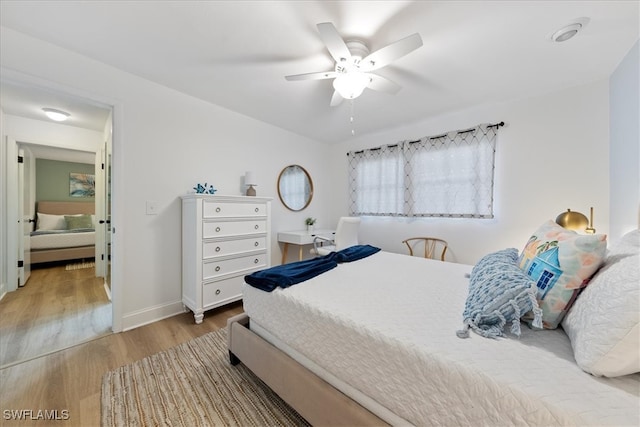 bedroom with ceiling fan and light wood-type flooring