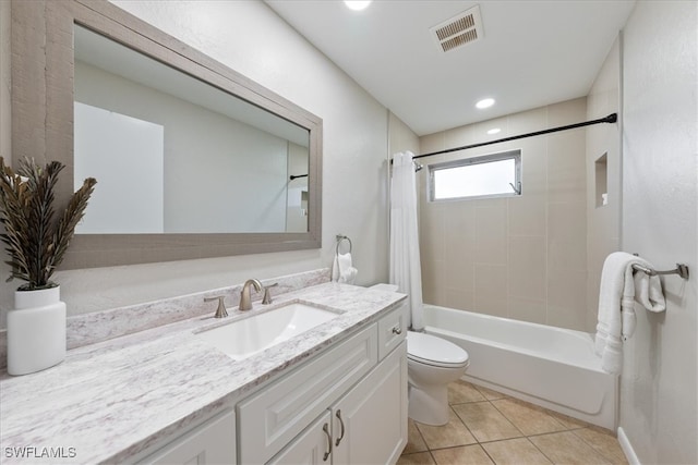 full bathroom with tile patterned flooring, vanity, toilet, and shower / bath combo with shower curtain