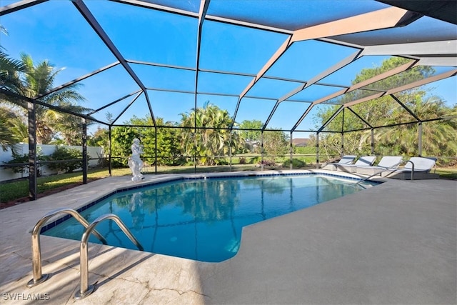 view of pool featuring glass enclosure and a patio area