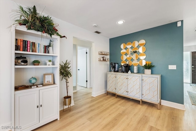 hall with light hardwood / wood-style floors