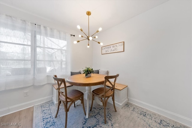 dining room featuring hardwood / wood-style floors and a chandelier