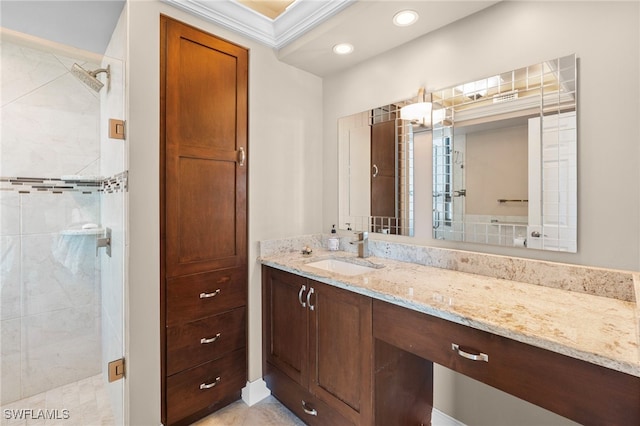 bathroom featuring vanity, ornamental molding, and walk in shower