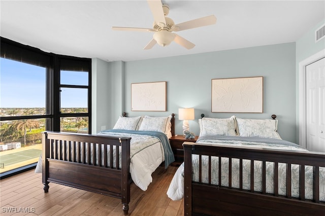 bedroom featuring a closet, hardwood / wood-style flooring, and ceiling fan