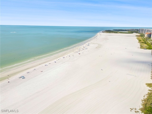 birds eye view of property with a view of the beach and a water view