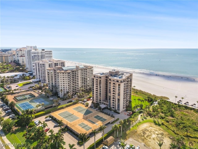 bird's eye view with a water view and a beach view