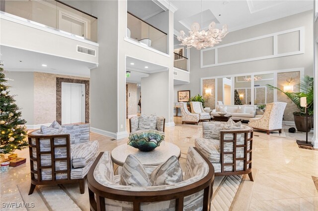 interior space featuring a chandelier, light tile patterned floors, a towering ceiling, and ornamental molding