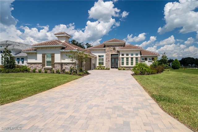 mediterranean / spanish-style home with a front lawn