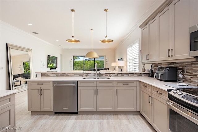 kitchen featuring stainless steel appliances, gray cabinets, sink, and a healthy amount of sunlight