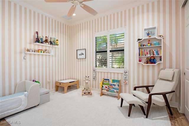 recreation room with hardwood / wood-style flooring, ceiling fan, and ornamental molding