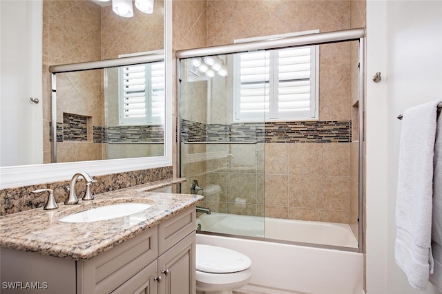 full bathroom featuring vanity, toilet, and enclosed tub / shower combo