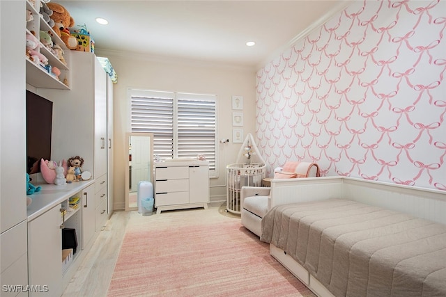 bedroom with light wood-type flooring and crown molding