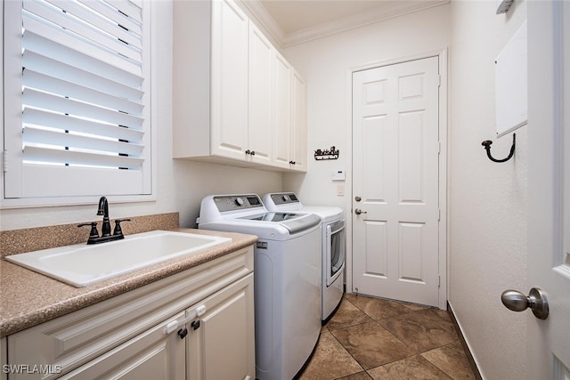 clothes washing area with cabinets, independent washer and dryer, ornamental molding, and sink