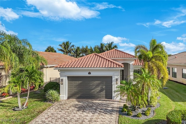 mediterranean / spanish-style home featuring a garage and a front lawn