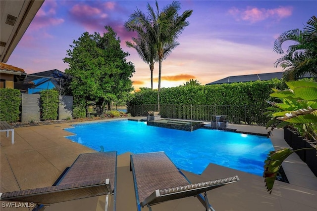 3565 Beaufort Ct, Naples, FL 34119 - pool at dusk featuring a fenced backyard, a patio, and a pool with connected hot tub