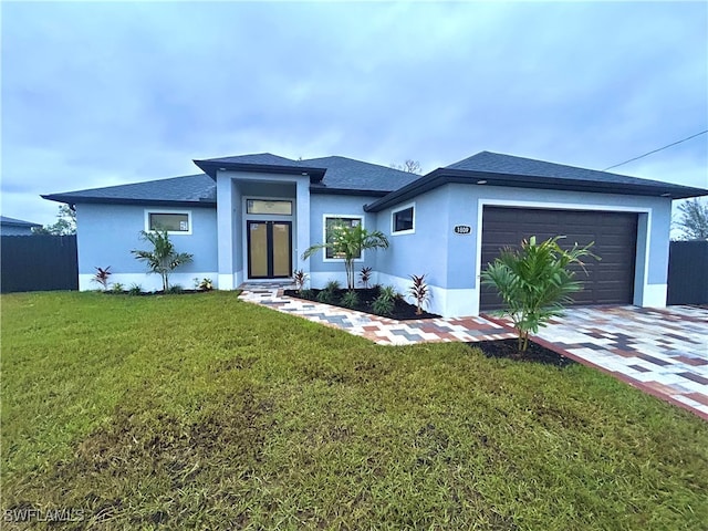 view of front of house featuring a front yard and a garage