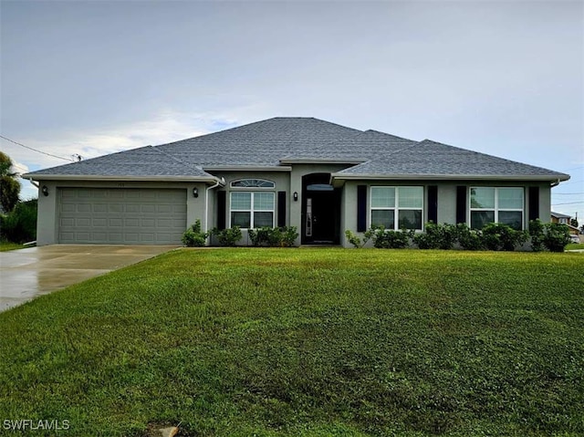 view of front of property with a garage and a front lawn