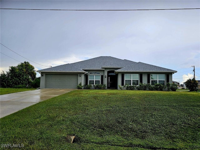 view of front facade with a garage and a front yard