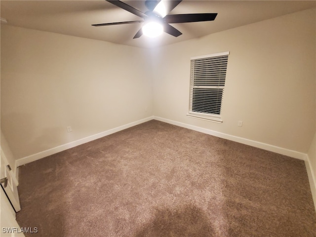 carpeted spare room featuring ceiling fan