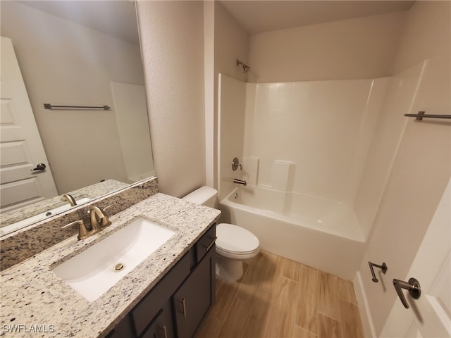 full bathroom featuring hardwood / wood-style floors, vanity, shower / bathtub combination, and toilet