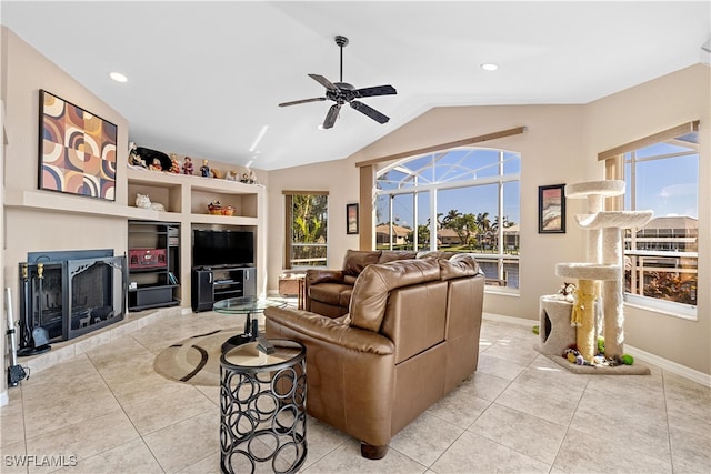 living room with ceiling fan, light tile patterned floors, and vaulted ceiling