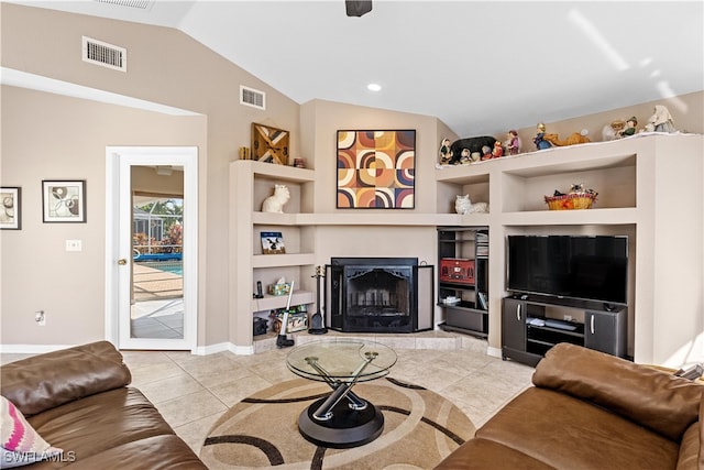 tiled living room with built in shelves and lofted ceiling