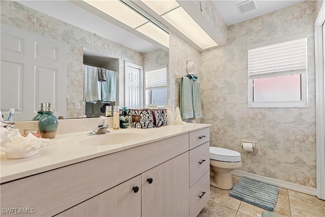 bathroom featuring tile patterned flooring, vanity, and toilet