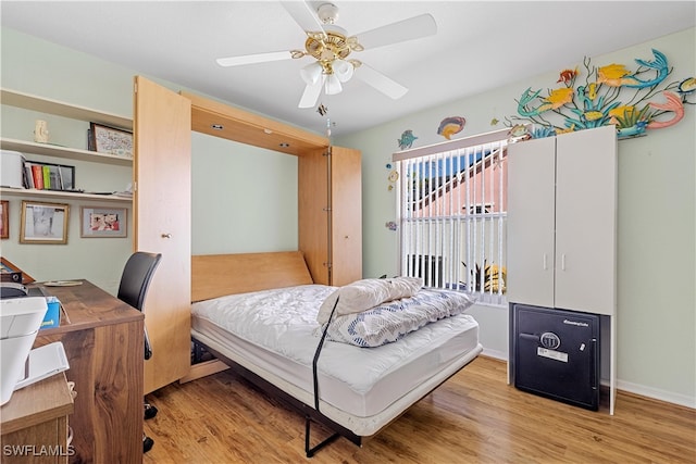 bedroom with light hardwood / wood-style floors and ceiling fan