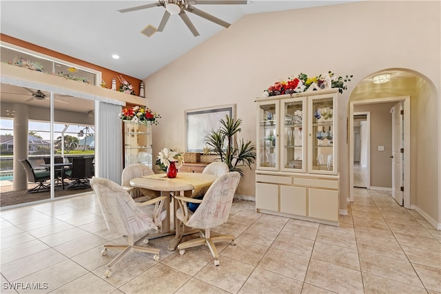 tiled dining room with high vaulted ceiling and ceiling fan