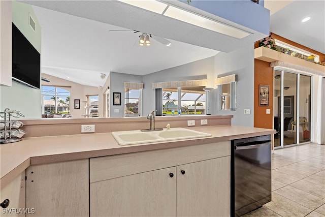 kitchen featuring sink, a healthy amount of sunlight, vaulted ceiling, and black dishwasher