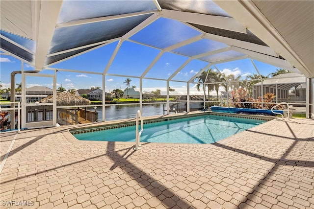 view of swimming pool with a lanai, a water view, and a patio