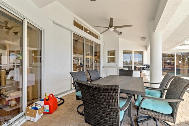 sunroom with ceiling fan and vaulted ceiling