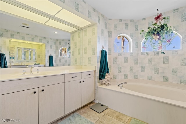 bathroom with tile patterned flooring, vanity, and a bathing tub