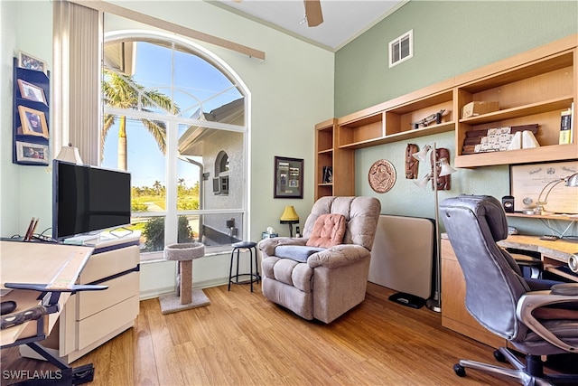 office area featuring ceiling fan, crown molding, and light hardwood / wood-style floors