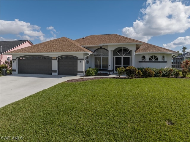 view of front of property featuring a garage and a front yard