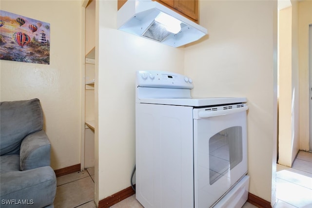 laundry area with cabinets and light tile patterned floors