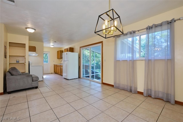 living room with light tile patterned floors and an inviting chandelier