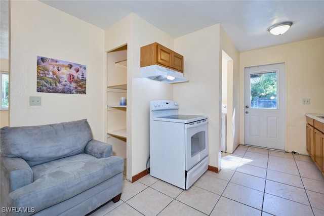 kitchen with electric range and light tile patterned floors