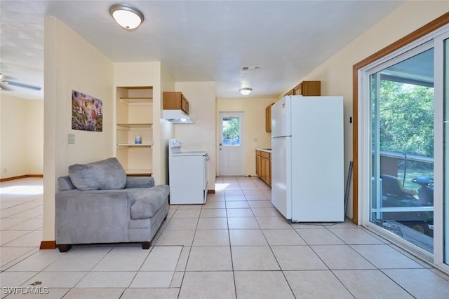 kitchen with light tile patterned flooring and white appliances