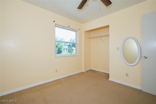 unfurnished bedroom with ceiling fan, light colored carpet, and a closet