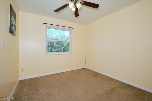 carpeted spare room with ceiling fan